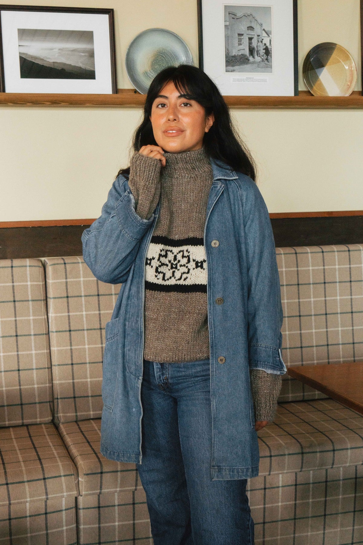 Hand knit flower sweater layered under a denim jacket, styled with jeans