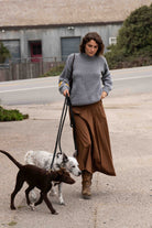 Banjo Blue hand-knit dog sweater by Made by Minga, worn walking two dogs on leashes