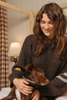 Buster Brown Best Buds sweater with embroidered flower and striped sleeve, holding a brown puppy