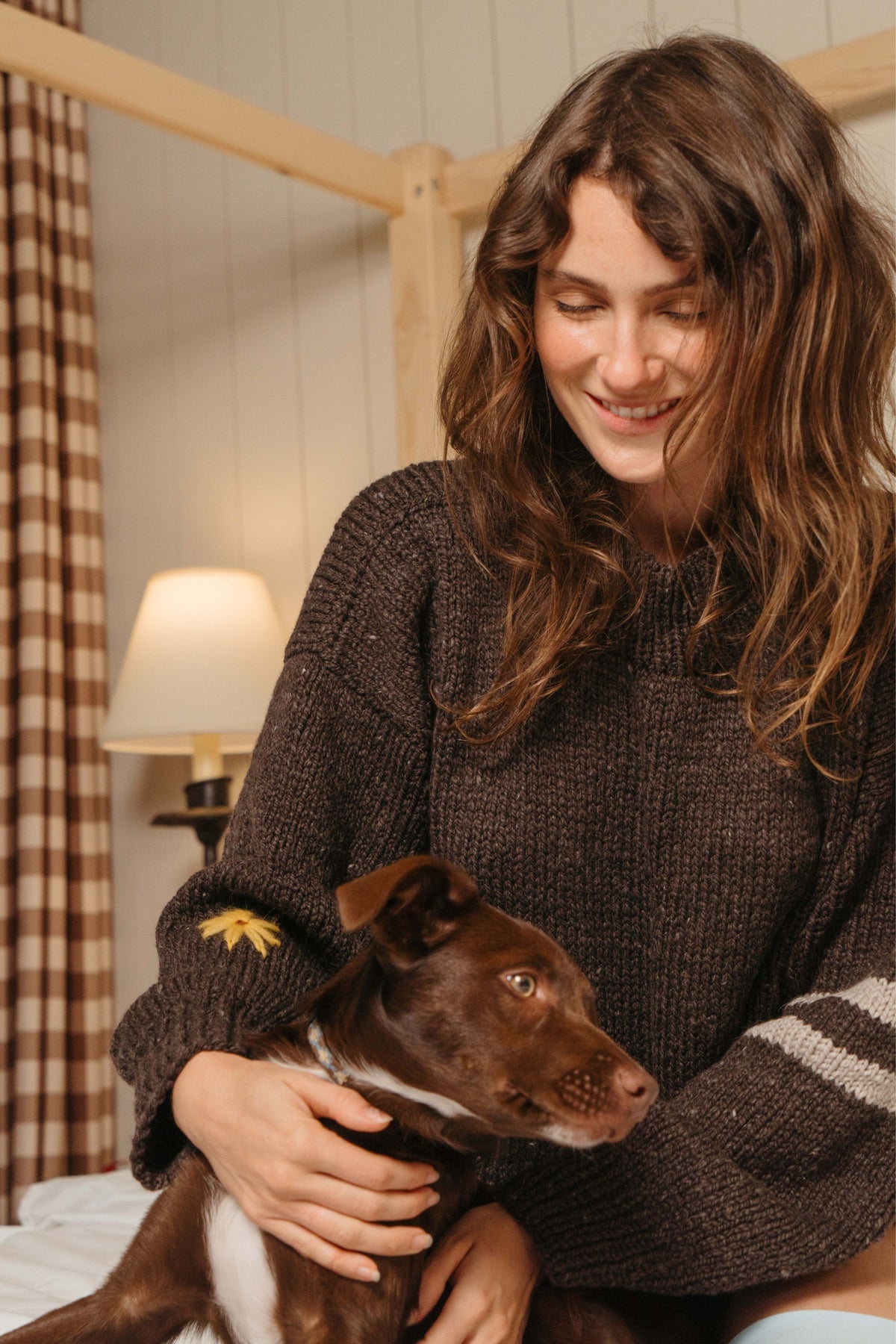 Buster Brown Best Buds sweater with embroidered flower and striped sleeve, holding a brown puppy